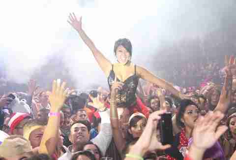 Lady sitting on shoulders in crowd