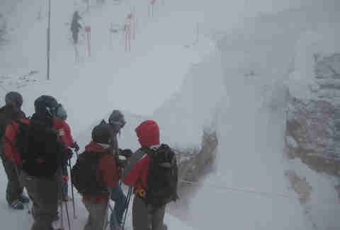 Skiers on the slope in a snowstorm