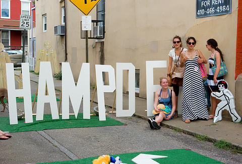 Baltimore people in front of letters