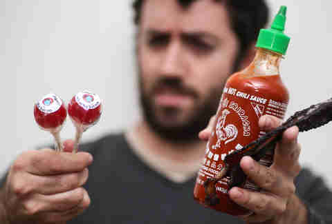 holding sriracha and lollypop