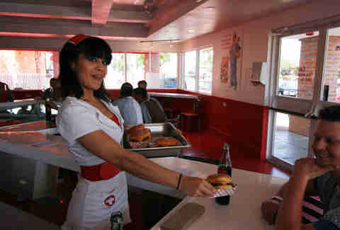 Waitress with burger at Heart Attack Grill