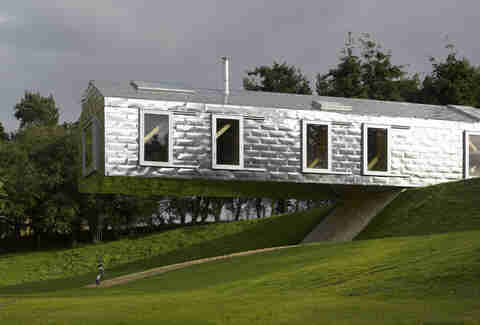 Balancing barn half-suspended in air, held sturdy by barely visible anchor
