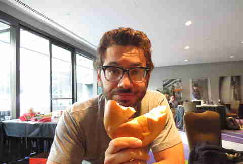 Al Madrigal eats a bagel