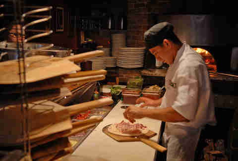 pizzaiolo in pizzeria kitchen