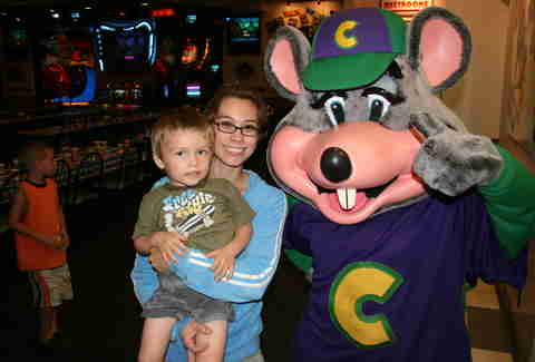 Chuck E. Cheese mascot with kid