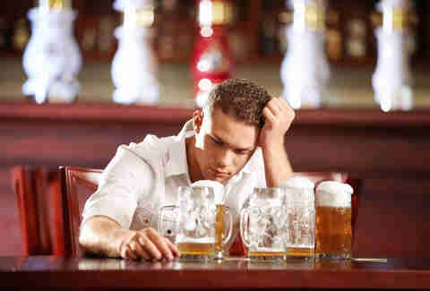 guy with beers sitting at bar