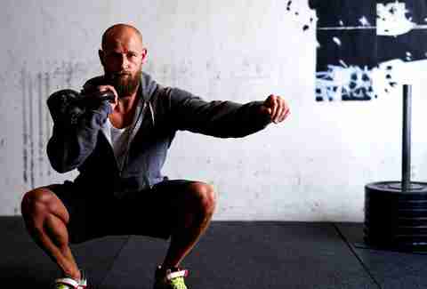 Man doing squats with weight
