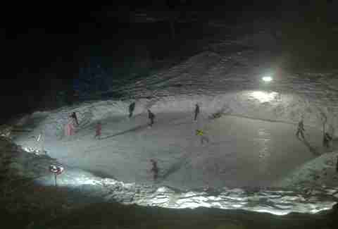 Friends skiing in frozen Minnesota pond