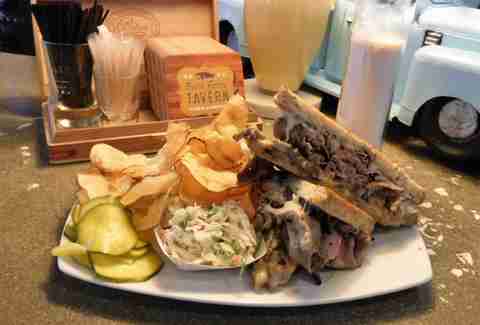 Plate with brisket sandwich and potato chips