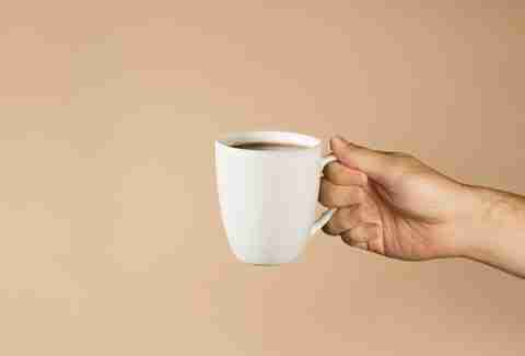 hand holding cup of coffee