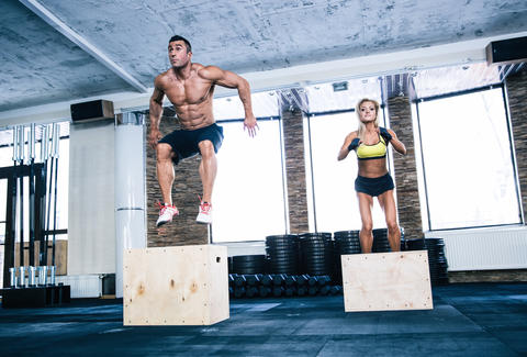 man and woman jumping on a fit box