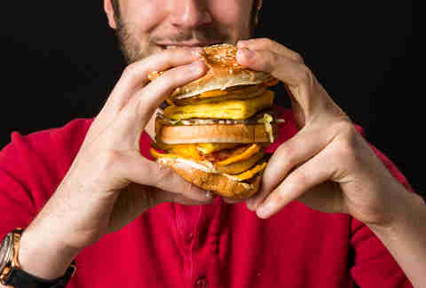 man eating big hamburger