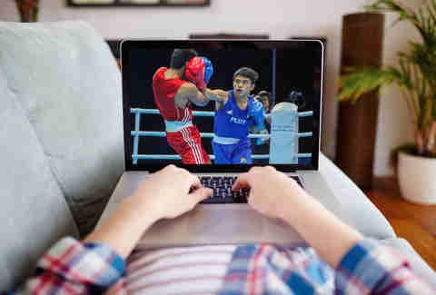 streaming a boxing match on a laptop