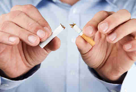 Smoker breaking cigarette