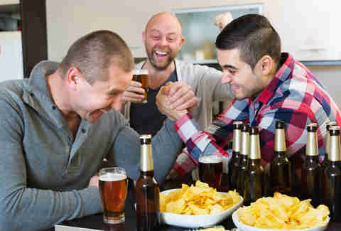 friends drinking and arm wrestling