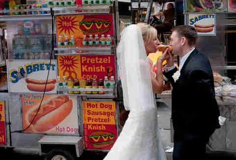 Bride and Groom eat a hot dog
