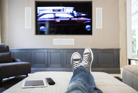 man watching TV on couch