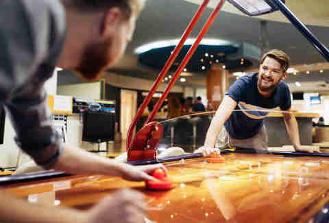 guys playing air hockey