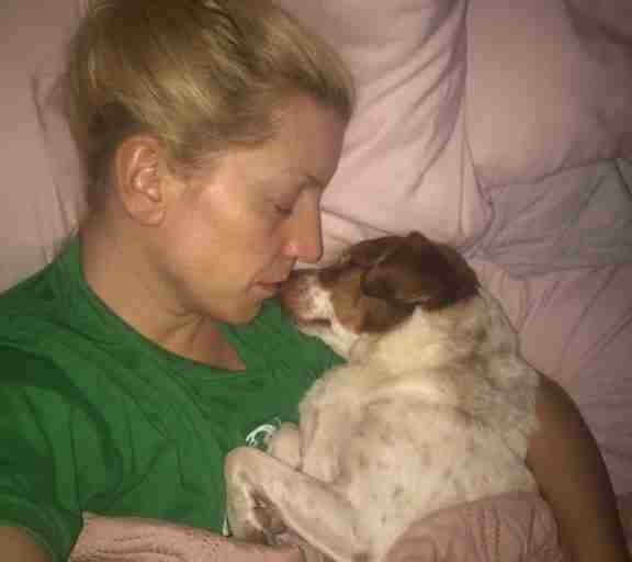 Jami snuggles her rescue dog George