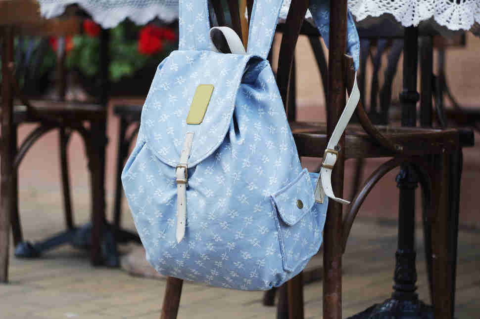 backpack hanging on back of chair