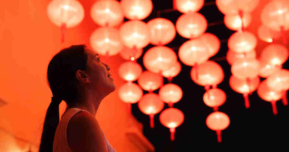 woman under lanterns