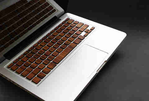 MacBook keyboard covered with wooden skins