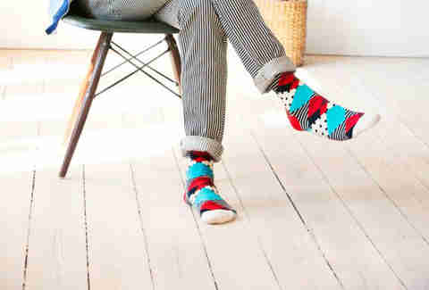 Guy sitting in colorfully striped socks