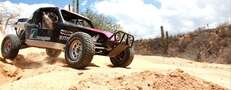 Race through the desert from hotel to hotel in a frickin' Mad Max car