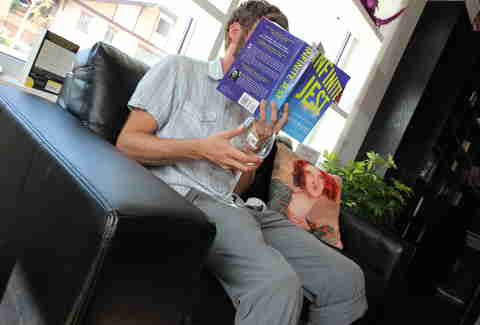guy reading a book at BookBar