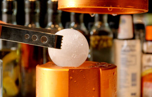 Beer cocktails and giant balls of ice in a Rittenhouse library