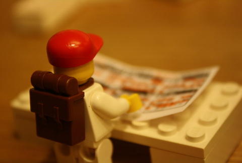 lego person reading paper