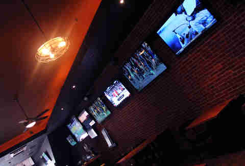 The TVs lining the dining room at Sto's Bar