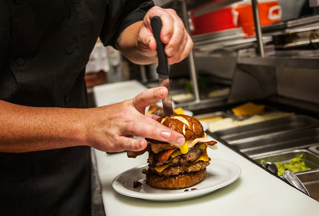 Chef places the final touch in the 'Merica Burger at Slater's 50/50 in San Diego.-This 'Merica Burger is basically 100% made of bacon