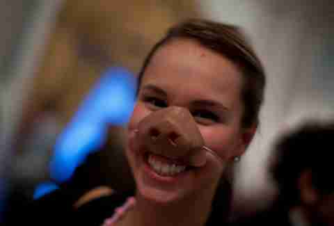 A girl wears a pig snout at a Cochon Epic event