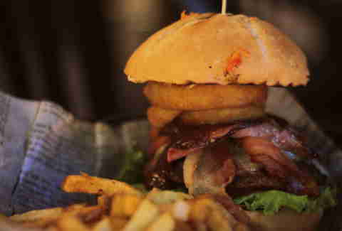 Burger with onion rings and fries