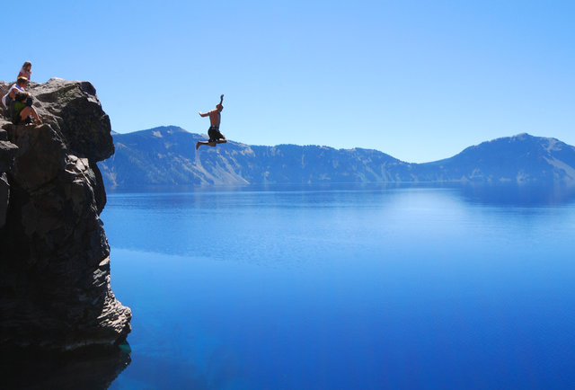 Another man jumping into water from a cliff