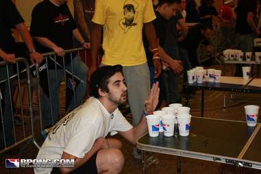 guy distracting another player in beer pong