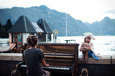 girl sits while woman plays piano