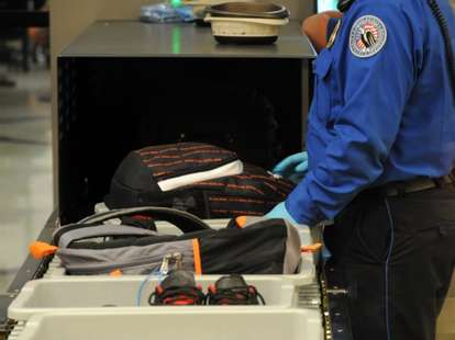 TSA security agent at airport checking baggage