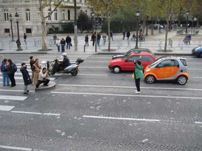 tourists taking pictures in the middle of the road