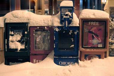 Chicago newspaper boxes covered in snow