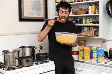 a guy eating mac and cheese