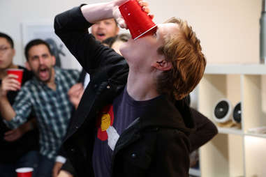 guy drinking beer in a flip cup game