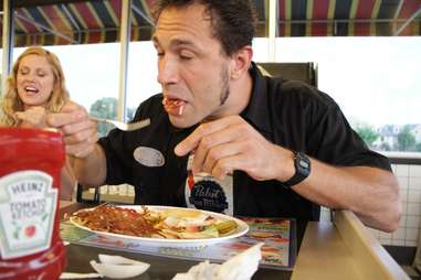 Guy eating Waffle House food