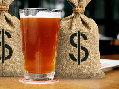 Pint of beer with money bags