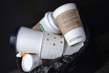 Trash can full of coffee cups