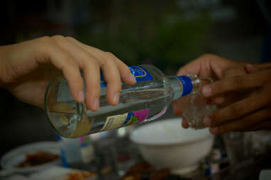 Person pouring soju into a cup