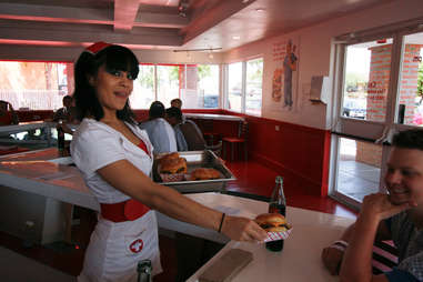 Waitress with burger at Heart Attack Grill