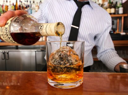 bartender pouring whiskey