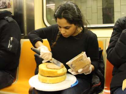 Woman frosting cake on the subway